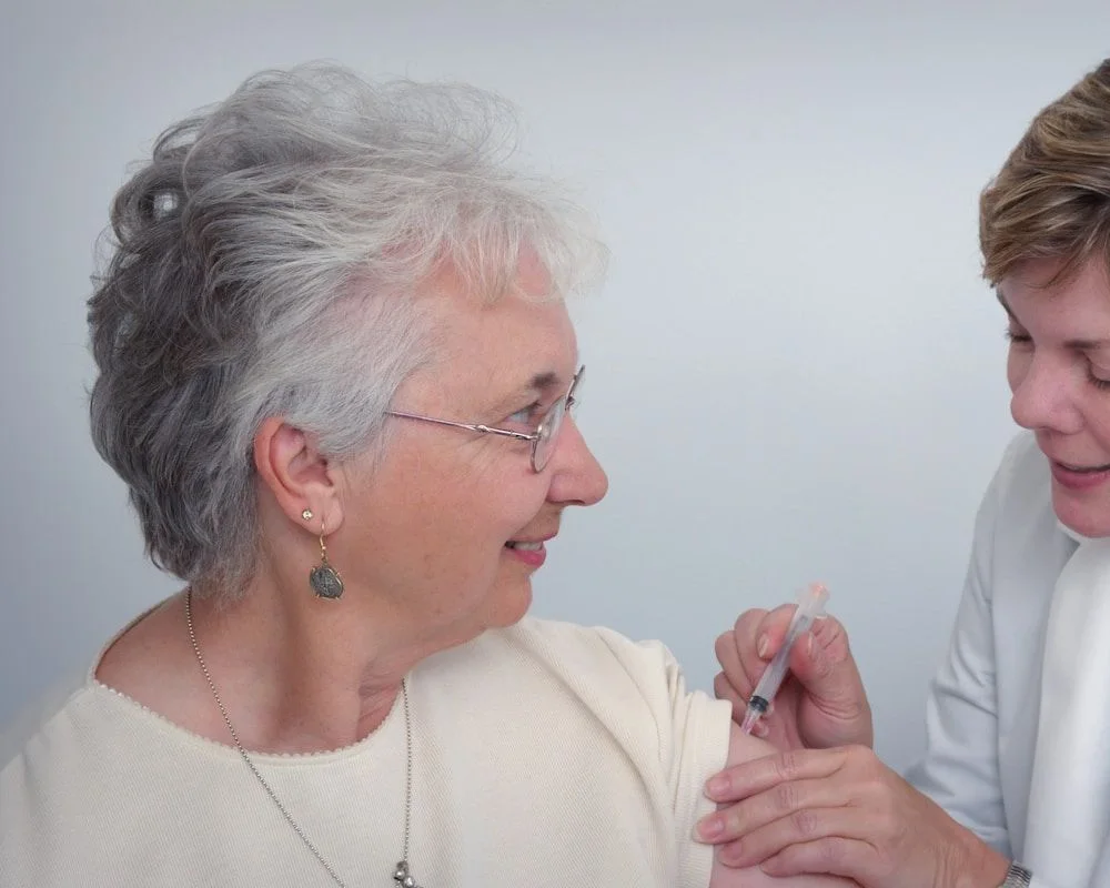 A clinician attending to an older adult during a one-to-one visit